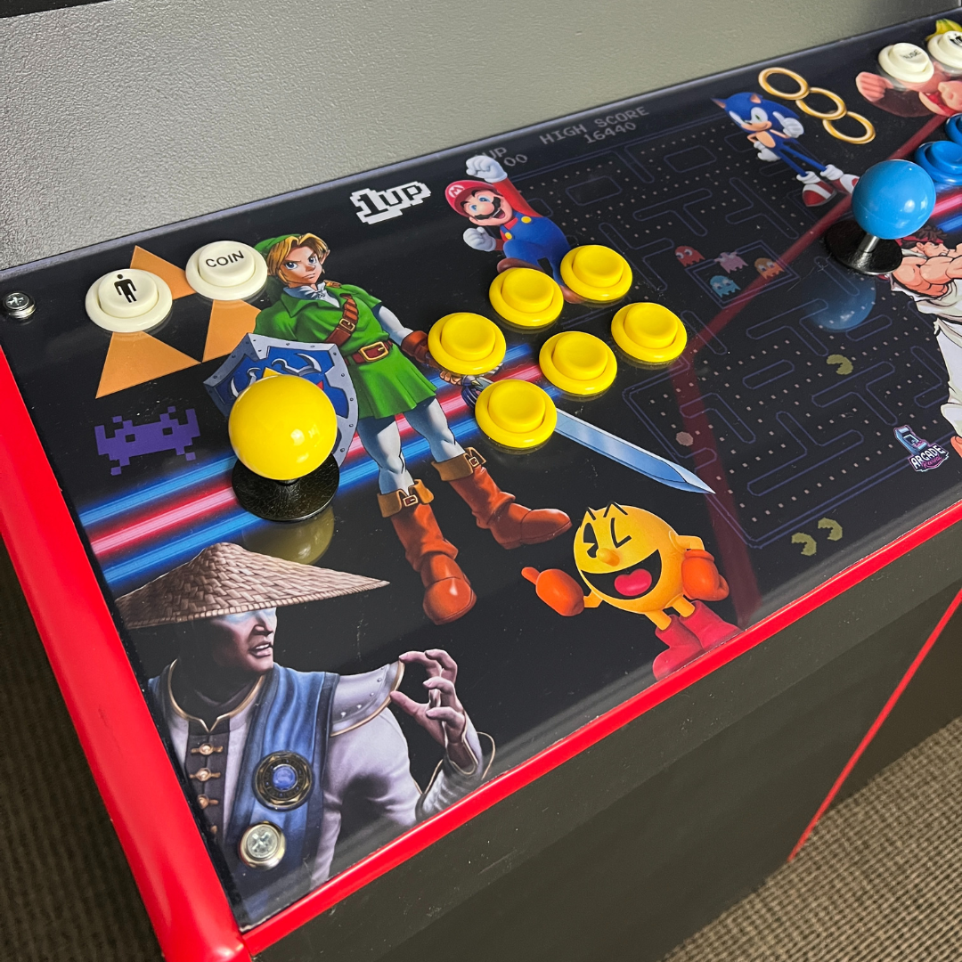 Close-up of Arcade All-Stars II control panel wrap installed on an arcade cabinet from Arcade Revival, showing yellow buttons and joystick.