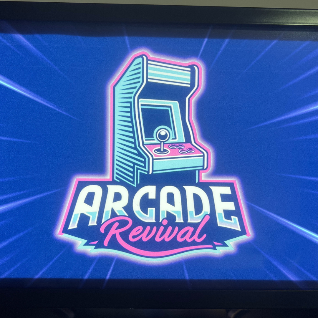 Close-up of the Arcade Revival illuminated logo featuring joystick artwork and vibrant light burst effect.