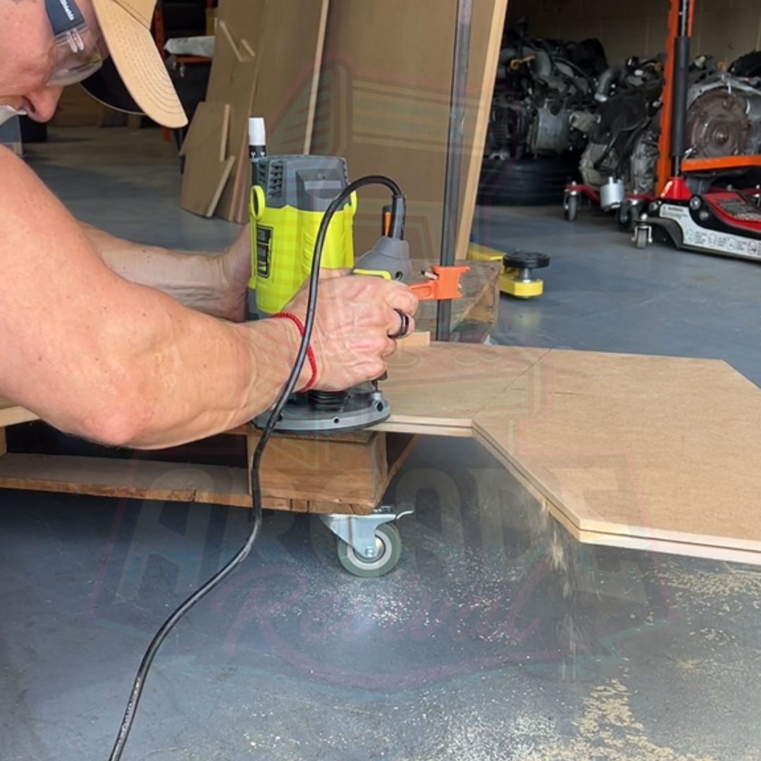 Close-up of slot cutting with a router for arcade cabinet edge using a T-moulding router bit