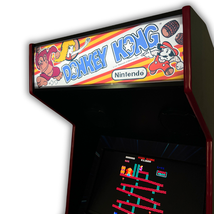 Side angle view of Donkey Kong reproduction marquee installed on arcade cabinet with classic design and red trim.