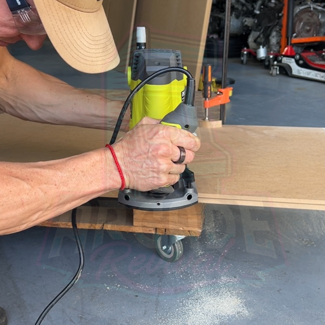 Routing the T-moulding slot into arcade cabinet side panel with guide in workshop