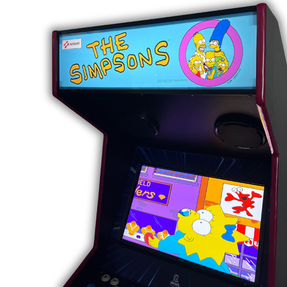 Angled close-up of The Simpsons arcade marquee reproduction glowing when backlit on cabinet